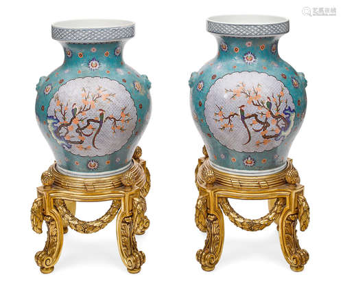 An impressive pair of Chinese enameled porcelain vases on giltwood stands