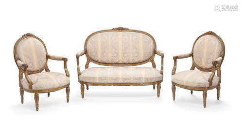 Circa 1900 A Louis XVI style giltwood canapé and pair of fauteuils