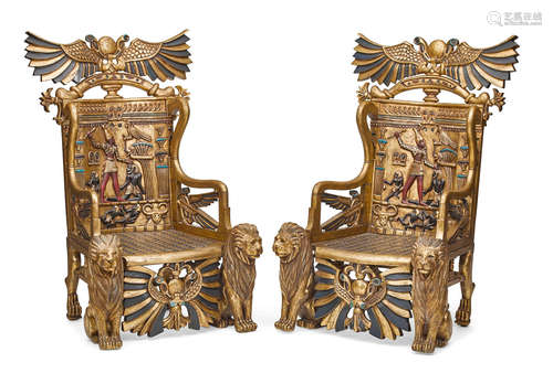 A pair of Egyptian style carved and painted giltwood throne chairs