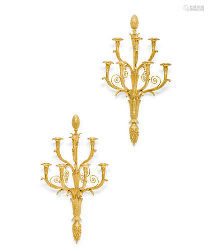 A pair of Empire style gilt bronze seven branch wall lights