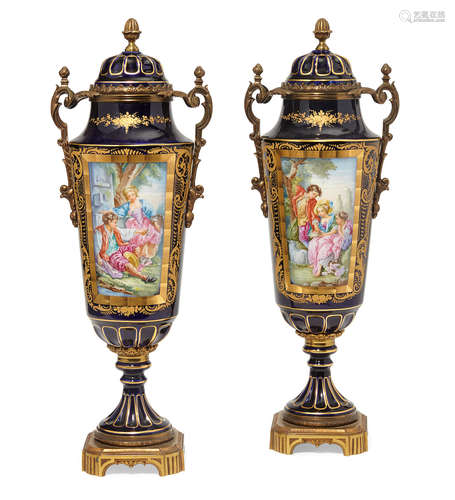 Early 20th century A pair of French Sèvres style gilt bronze mounted porcelain covered urns