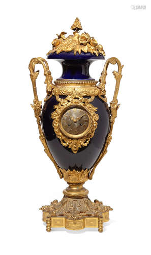 Circa 1900 A French gilt bronze mounted blue porcelain urn form clock