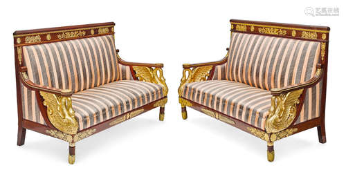 An impressive pair of Empire style gilt bronze mounted and giltwood mahogany sofas