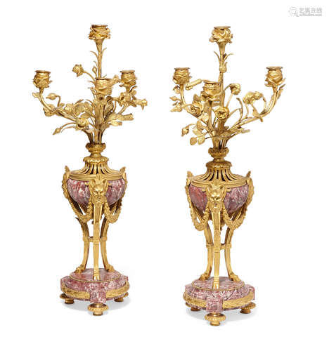 Late 19th century A pair of Louis XVI style gilt bronze and marble four light candelabra