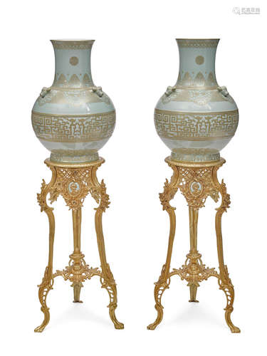 A pair of Chinese gilt heightened porcelain vases on gilt bronze stands