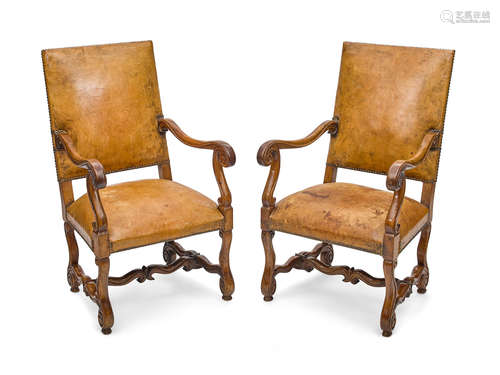 18th century A pair of Louis XIV leather upholstered walnut armchairs