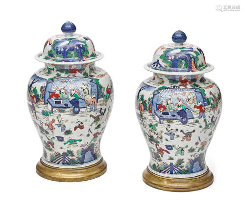 A pair of Chinese porcelain lidded jars on bronze bases