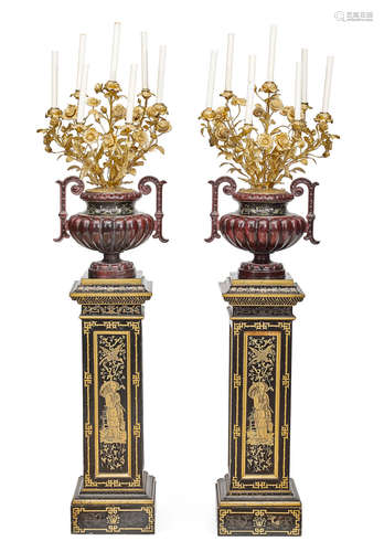 A pair of French parcel gilt and enameled iron seven light candelabra on japanned pedestals