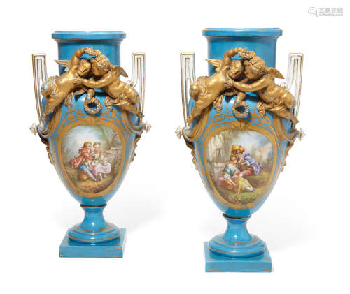 Late 19th century A pair of Sèvres style porcelain two handled vases with applied putti