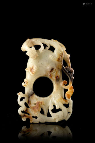 A celadon and russet jade plaque with incised decoration of archaistic dragons and ritual
