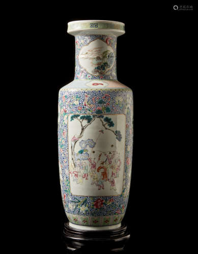 A Famille Rose rouleau vase decorated with panels depicting boys at play and auspicious objects,