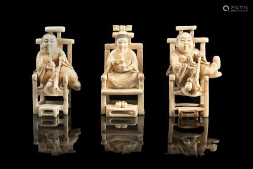 Three ivory netsukes depicting smokers seated on chairs, signedJapan, Meiji period (1868-1912)