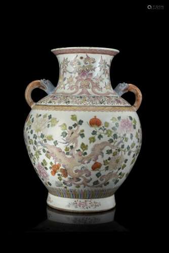 A twin-handled Famille Rose vase decorated with archaic phoenix amongst peaches and flowering