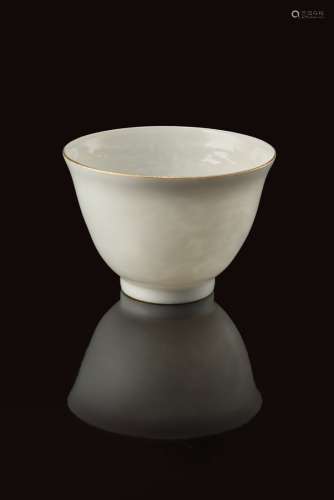 An anhua decorated white cup, with delicately incised dragons and gilt rim, with an apocryphal