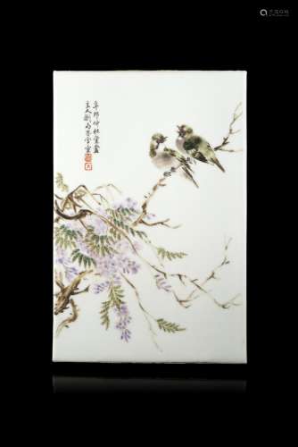 A rectangular porcelain plaque decorated with a pair of birds amongst flowering hysteria branches,