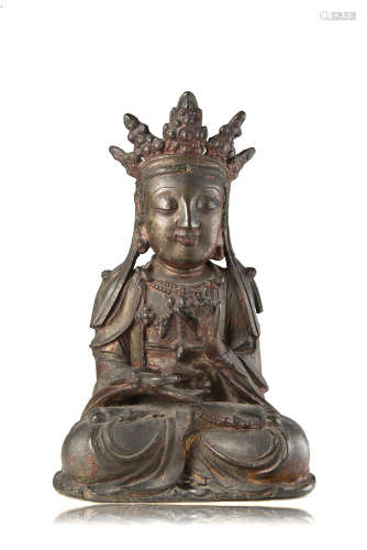 A lacquered and gilt bronze model of a Buddha (defects)China, Ming dynasty (1368-1644)(h. 24.5 cm.)