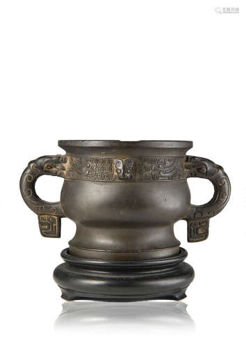 A bronze censer of archaistic shape, gui, wood base (defects)China, Ming dynasty (1368-1644), 17th