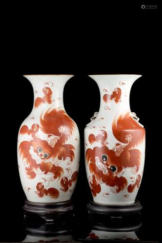 Two porcelain vases decorated in iron red with buddhist lions, wood basesChina, 20th century(h. 43