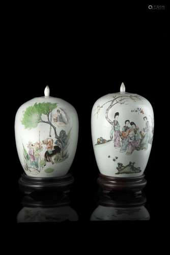 A pair of potiches and covers decorated in polychrome enamels with figures in gardens, wood base (