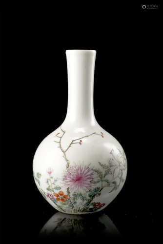 A small polychrome enamelled porcelain vase, decorated with flowers, with an iron-red mark to the