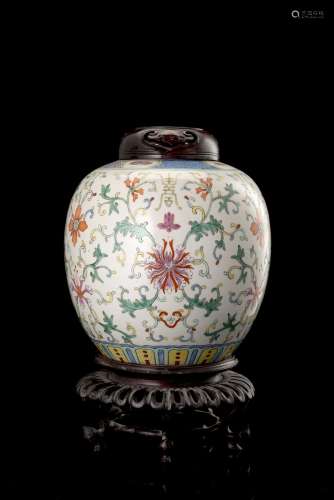 A polychrome-decorated potiche decorated with floral motifs, with carved wood cover and baseChina,