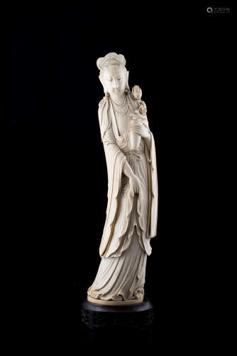 An ivory sculpture of Guanyin carrying a vase and flowering peonies, wood base (defects)China,