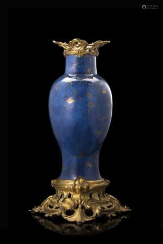 A powder-blue porcelain vase decorated with gilded floral motifs, with ormolu mounts. The porcelain: