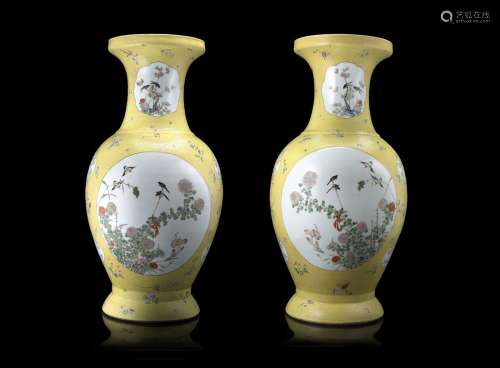 A pair of large Famille Rose vases, each decorated to the body with panels depicting a pair of