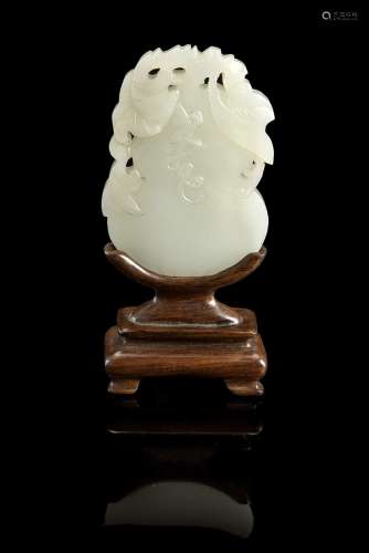 A small celadon jade plaque of double-gourd form with incised 