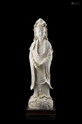 A Blanc-de-Chine model of a standing Guanyin, with wood base (defects and restorations)China, Qing