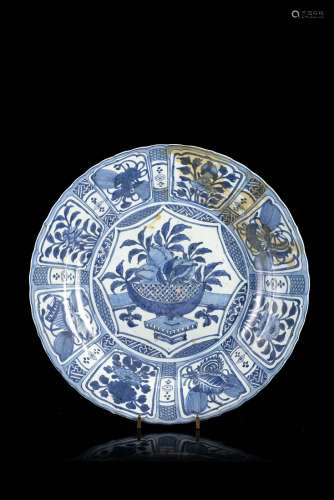 A large blue and white 'kraak' dish decorated to the centre with a basket of flowers, the border