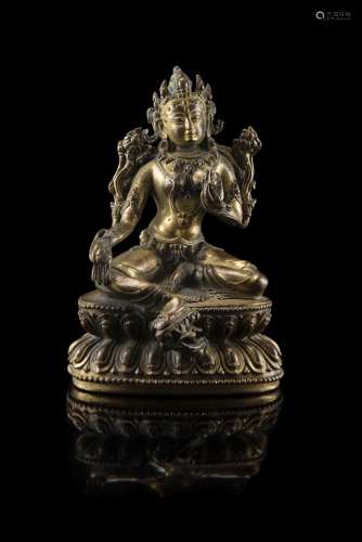 A gilt bronze model of a green Tara, seated on a double lotus base in a lalitasana, the loose