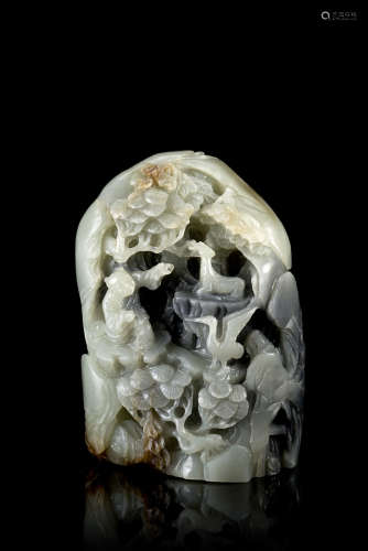 A grey and russet jade boulder, carved with a boy and various animals in a wooden grove, with
