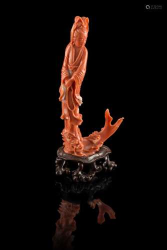 A coral model of a Guanyin standing on a dragon, with wood baseChina, 20th century(h. 8x5 cm.; gross