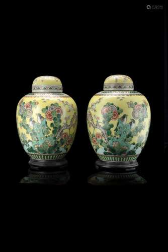 A pair of yellow ground Famille Verte potiche and covers decorated with birds and flowers (