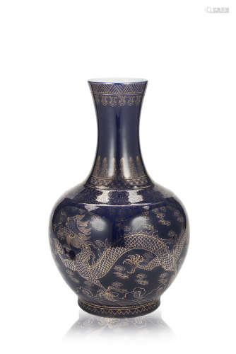 A powder-blue bottle vase with gilt decoration of dragons, with a Guangxu seal mark to the base