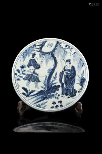 A blue and white circular plaque decorated with an official and warrior beneath treesChina, 20th