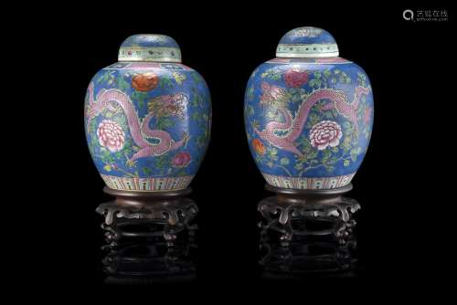 A pair of polychrome potiche decorated with phoenix amongst flower, wood base (slight defects)China,