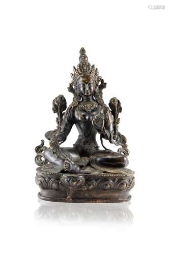 A gilt-bronze figure of Tara seated on a lotus base, wearing a crown and jewelry (slight defects)
