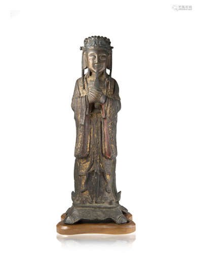 A gilt and lacquered bronze model of a scholar, wood base (defects)China, Ming dynasty (1368-1644)(
