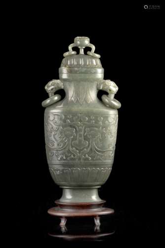 A nephrite vase with twin ring handles and cover, decorated with a pair of phoenix, with wood