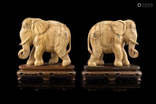 A pair of ivory elephants, with inset hardstones, wood basesChina, late 19th century(l. max 15 cm.)