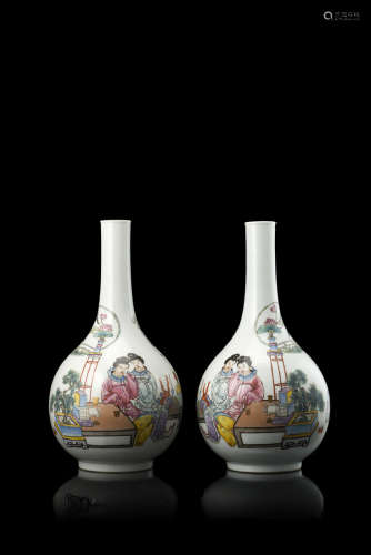 A pair of mirror-image porcelain bottle vases enamelled with two ladies in an interior with