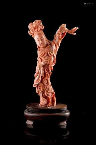 A coral carving of a lady wearing long robes, with wood baseChina, 20th century(h. max 19.5 cm.;