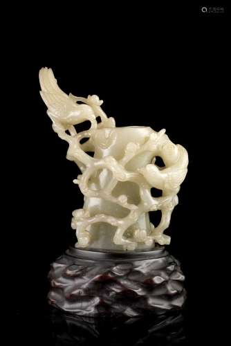 A celadon jade brushpot shaped as a prunus trunk decorated with a pair of magpied amongst