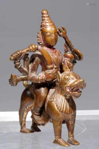 DURGAbronze,Nepal, 16th century,H: 10 cmIt is eight armed Dura sitting astride her vahana, lion. A
