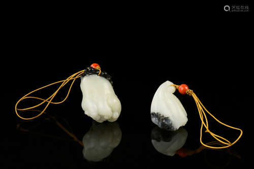 TWO BLACK AND WHITE JADE CLEVERLY CARVED ORNAMENTS