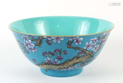 CHINESE PORCELAIN BLUE ENAMEL BOWL - Decorated on the exterior wall with a gnarly branch and pink and white plum blossoms.