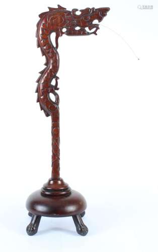 CHINESE CARVED WOOD DRAGON TABLE LAMP - Carved dragon head surmounts a serpentine pole anchored by a round paw footed base. Lamp is...