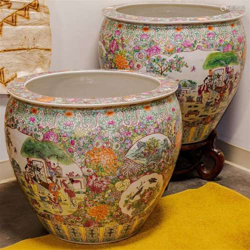 PAIR OF FISH BOWLS ON STANDS - Chinese famille rose ceramic; each with multiple pictorial vignettes on a dense floral ground and int...